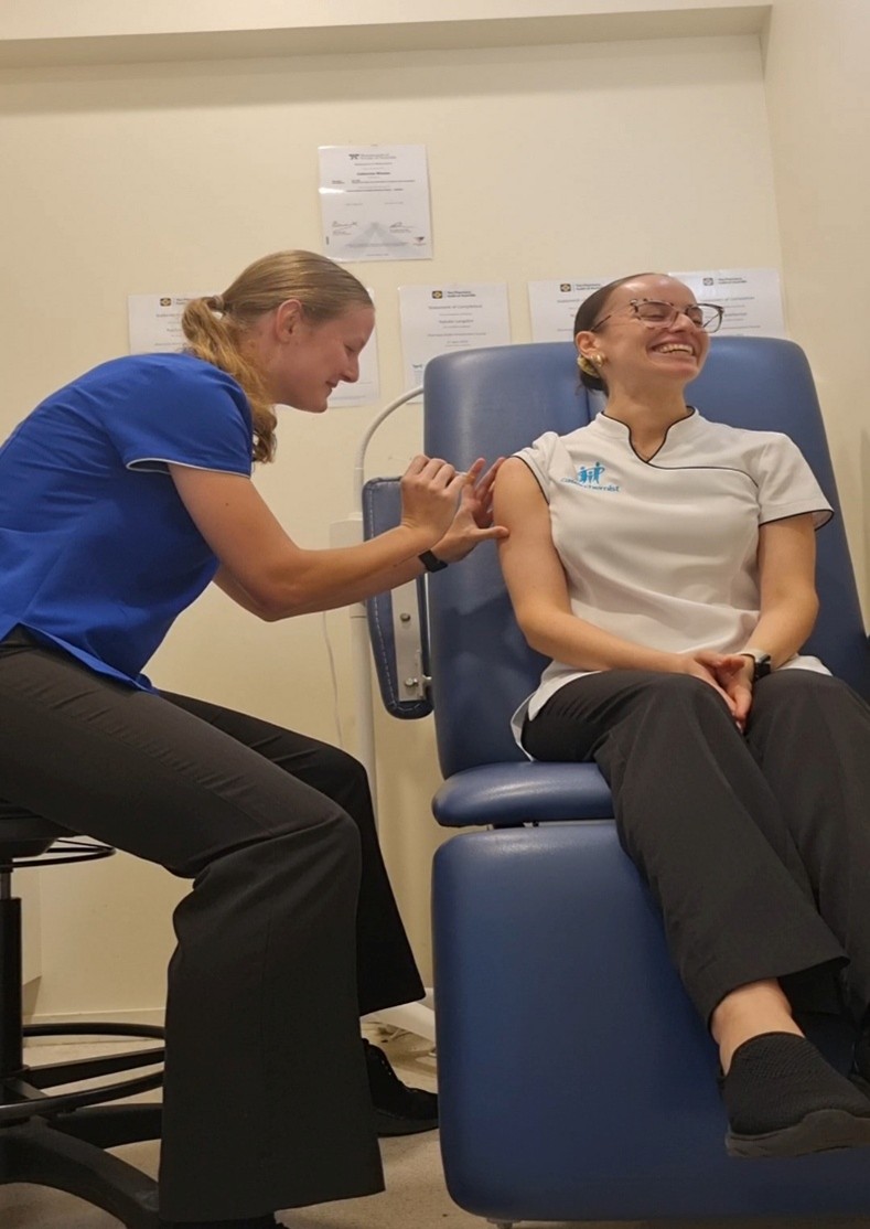 Natalie (pictured) in action and using her expertise as a qualified student immuniser to vaccinate a colleague.   